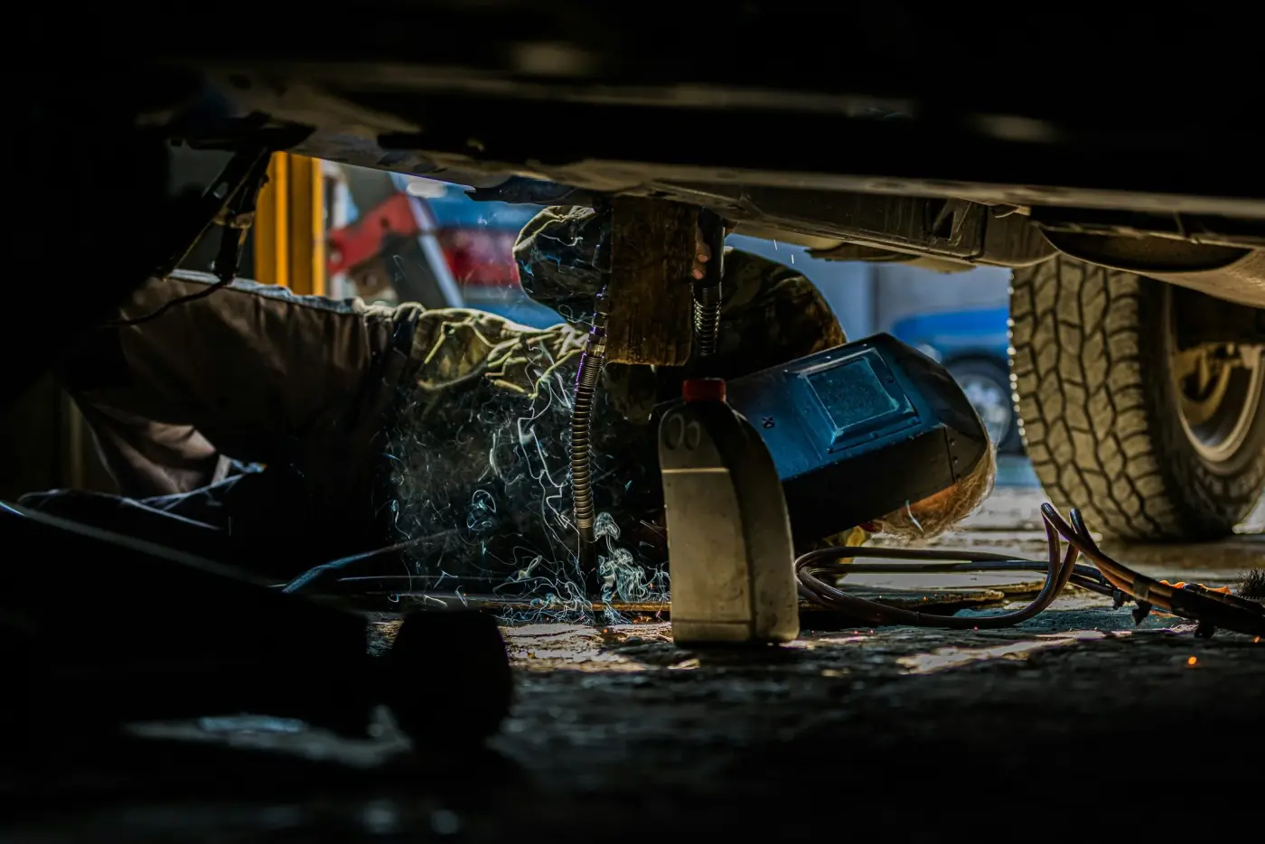 Welding a rocker panel behind a face shield