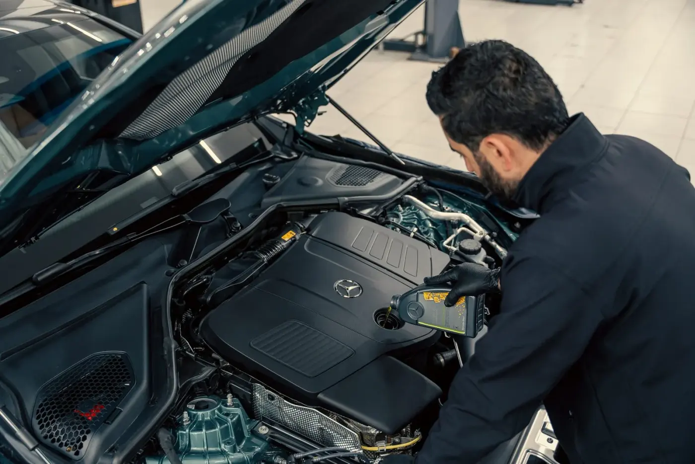 Pouring fresh oil into an engine