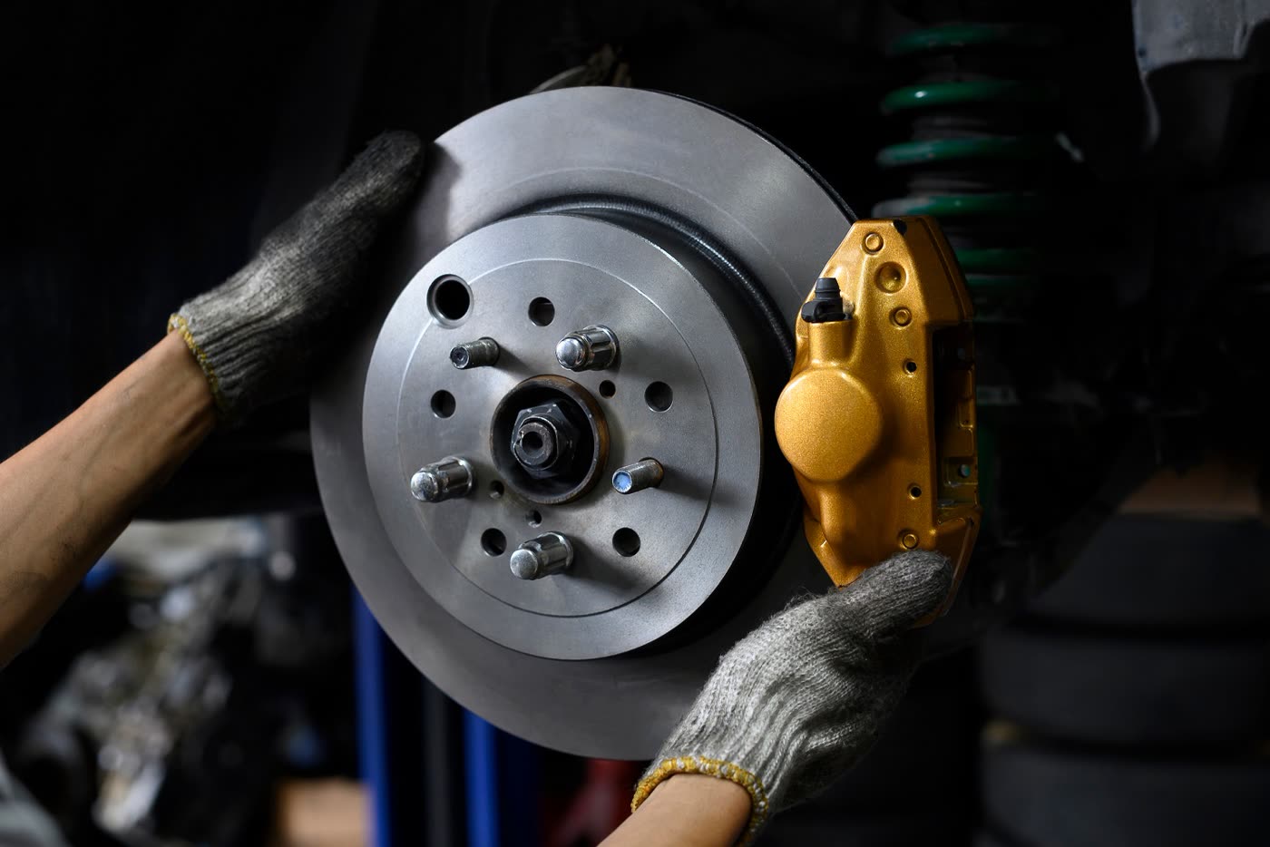 A brake rotor off the hub with the caliper still mounted