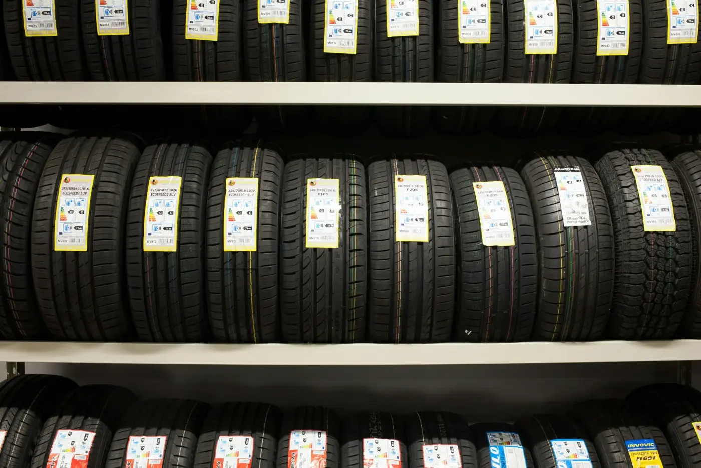 Rows of tires racked on shelves in the shop