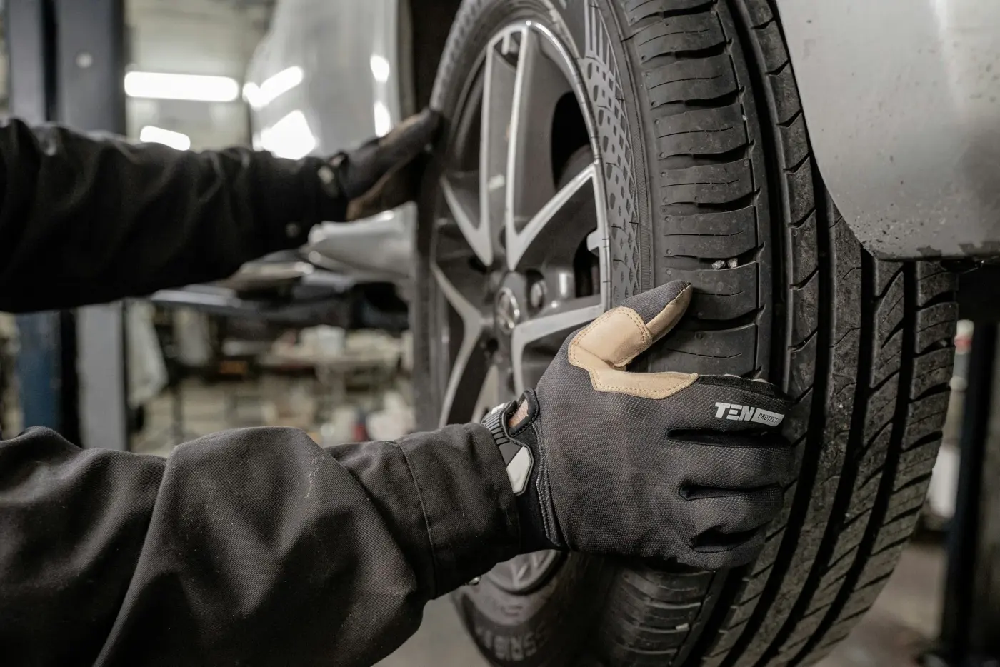 Checking a wheel for play with the car on the hoist